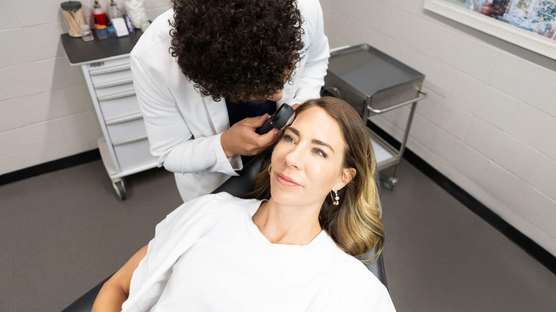 Dermatologist examining a patient at Paragon Skin & Surgery clinic.